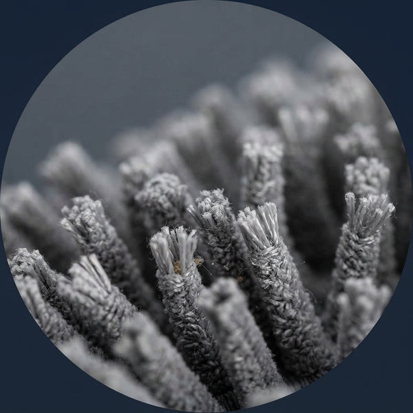 Close-up macro view of split-end microfiber bristles on a car duster designed to trap dust particles.